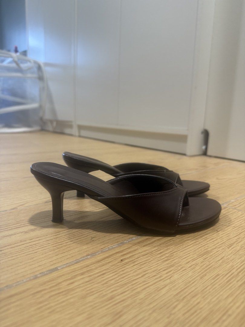 Dark Brown Thong Kitten Heel Mules Size 36 (Category: Heels) located in Manila. Submitted by iya.prlta (Listing ID 1469999603, Image 2). Description: - Color: Dark brown - Style: Thong-style kitten heels, slip-on with open pointed toe - Heel: Low heel for easy walking - Size: 36 (stamped on sole) - Condition: Worn once, minor light dirt on soles from outdoor wear.