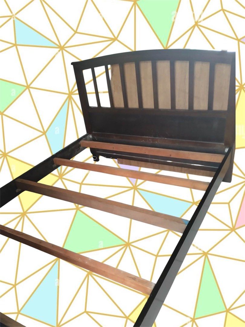 Dark brown wooden bed frame with bed mattress (Category: Bed Frames & Mattresses) located in Quezon City. Submitted by flrsgela (Listing ID 1470097472, Image 3). Description: - dark wood bed frame - Classic headboard with vertical slats - Ready for a new home - Bedsheet not included - Slightly negotiable - Double size bed.
