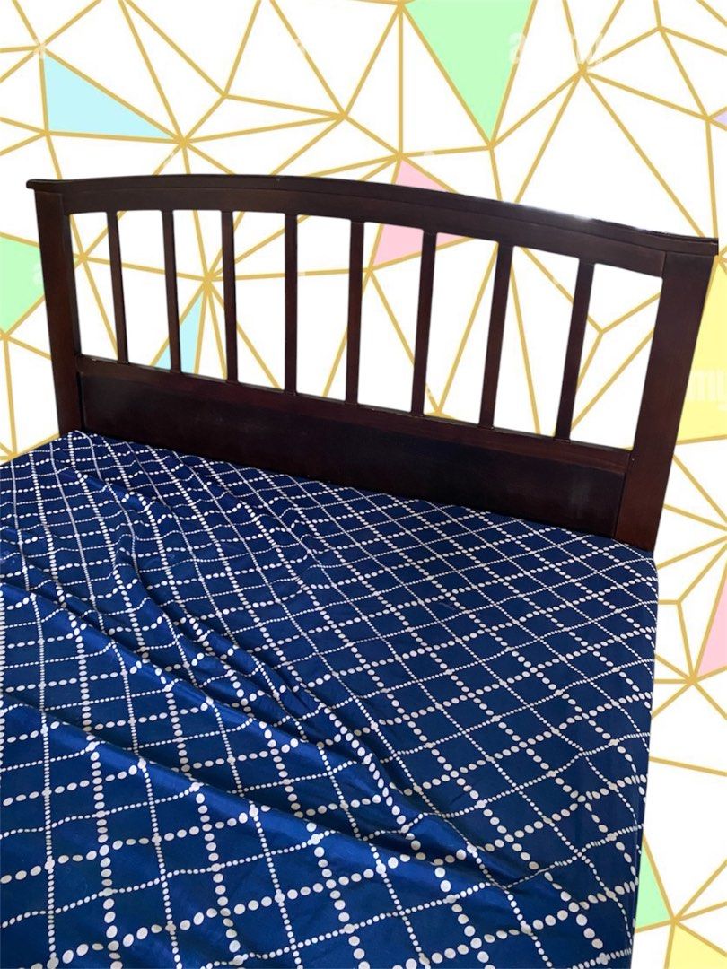 Dark brown wooden bed frame with bed mattress (Category: Bed Frames & Mattresses) located in Quezon City. Submitted by flrsgela (Listing ID 1470097472, Image 1). Description: - dark wood bed frame - Classic headboard with vertical slats - Ready for a new home - Bedsheet not included - Slightly negotiable - Double size bed.