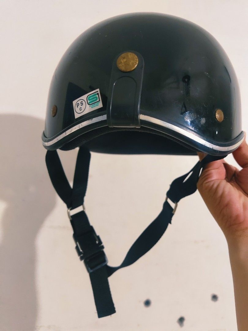 Dark Green Half Face Helmet with Strap (Category: Caps & Hats) located in Bulacan. Submitted by babz30261 (Listing ID 1470090352, Image 3). Description: - Color: Dark green with stylish silver trim - Design: Half-face shell with standard safety stickers - Comfort: Fully padded interior lined in black - Security: Adjustable black chin strap with quick-release buckle and metal hardware - Use: Perfect and reliable for everyday commuting.