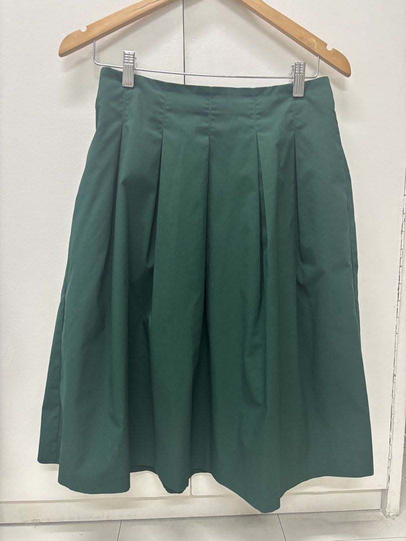 Dark Green Pleated Midi Skirt (Category: Skirts) located in Manila. Submitted by lovenewseason (Listing ID 1470059028, Image 2). Description: - Color: Dark green - Style: Pleated midi skirt with structured pleats - Length: Mid-length (falls just below the knee) - Details: Clean waistband with neat stitching - Versatility: Easy to pair with sweaters, tops, or jackets for casual or smart outfits - Condition: Clean fabric, hangs nicely.