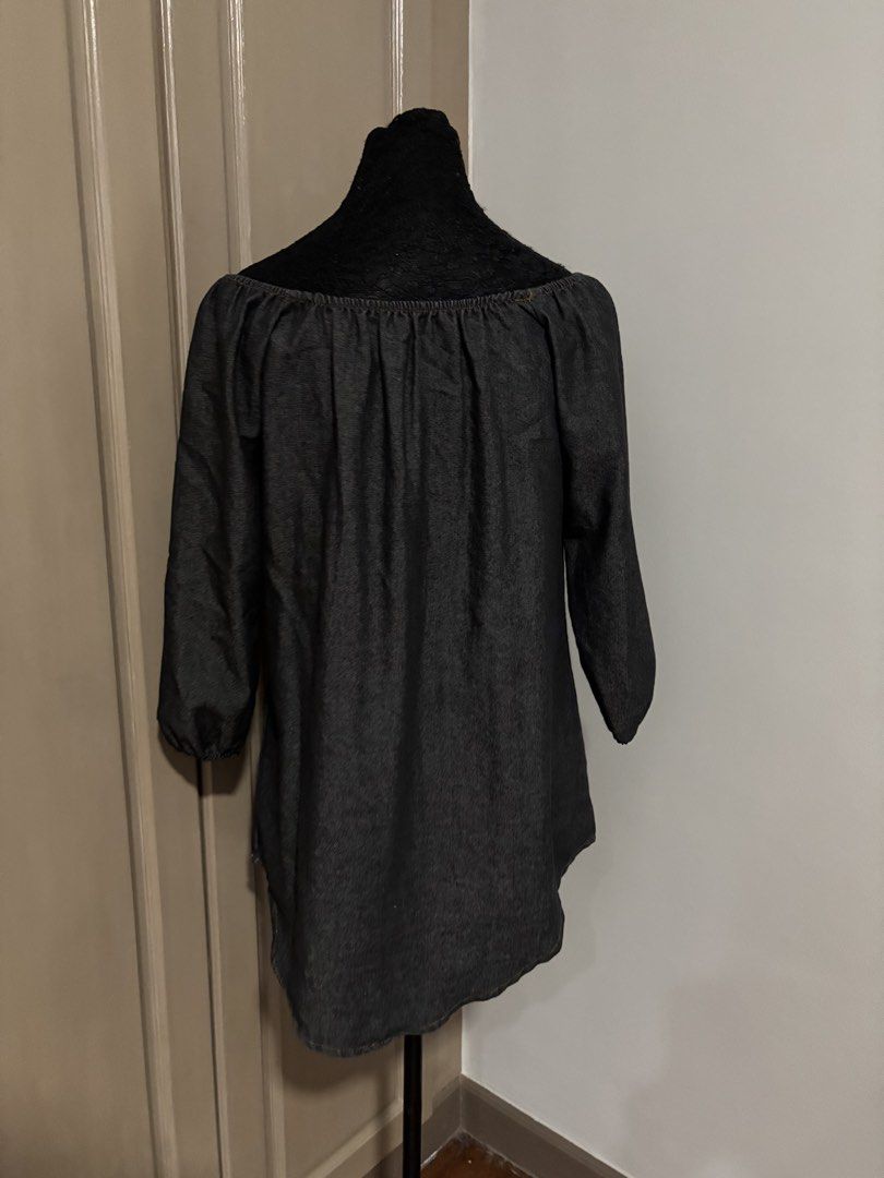 Dark Grey Denim Off-Shoulder Dress (Category: Blouses) located in Quezon City. Submitted by ada_412 (Listing ID 1470128697, Image 2). Description: - Color & Material: Dark grey, soft and lightweight chambray denim - Neckline: Trendy off-shoulder design with functional front buttons - Sleeves: Three-quarter length with comfortable gathered elastic cuffs - Details: Stylish gathered pleats along the back yoke.