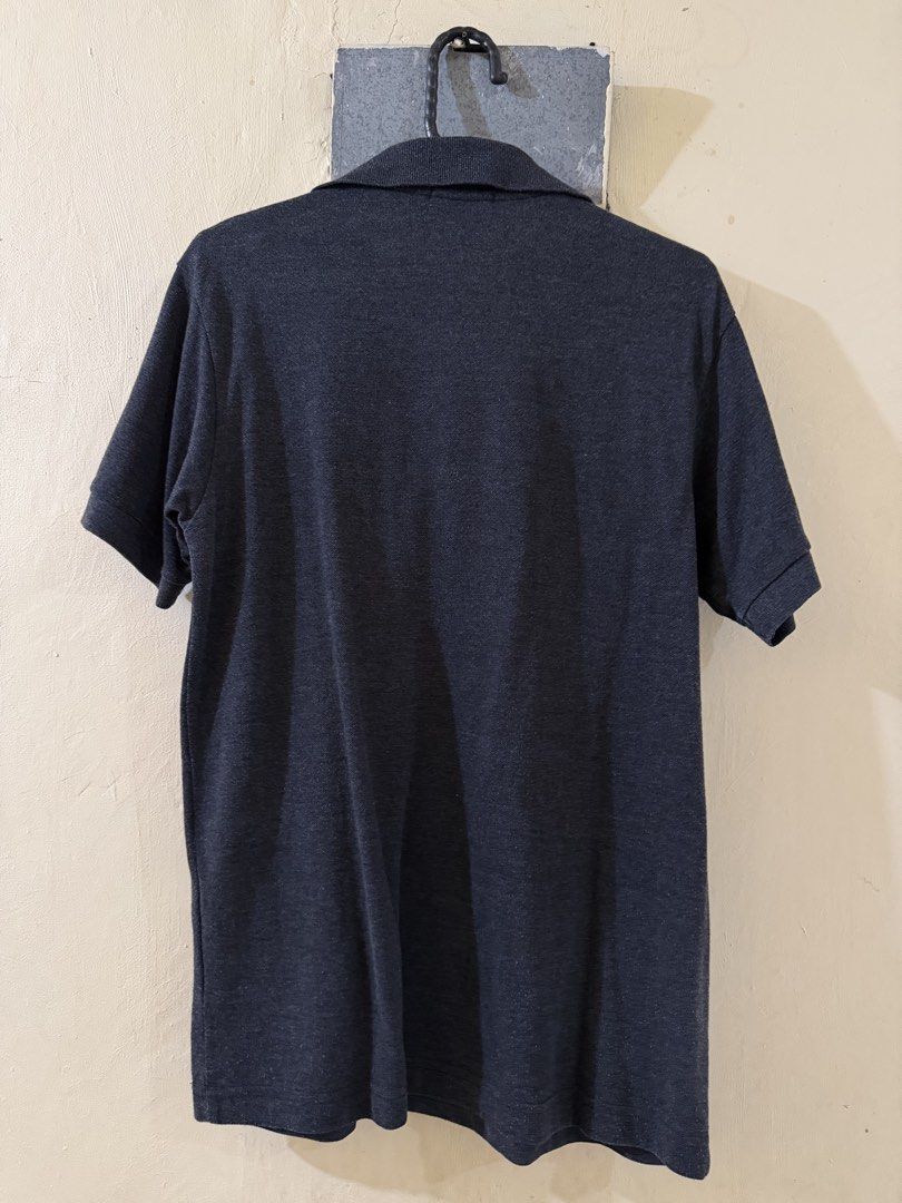Dark Grey Polo Shirt (Category: Tshirts & Polo Shirts ) located in Las Pinas. Submitted by rareriroruru (Listing ID 1470053682, Image 2). Description: - Color: Dark grey - Size: XS - Length: 26 in - Width: 18 in - Style: Short sleeves with ribbed cuffs, classic fold-over collar, two-button placket, plain back - Condition: Excellent casual staple for daily wear - Versatility: Solid color that easily pairs with most bottoms.