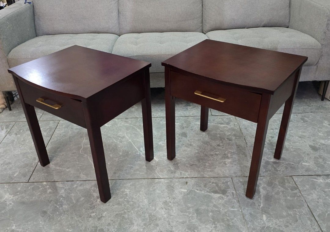 Dark Wood Bedside night table Mahogany (Category: Shelves, Cabinets & Racks) located in San Juan City. Submitted by YardSaleSanJuan (Listing ID 1469983845, Image 3). Description: - Set of 2 dark wood bedside tables - Single pull-out drawer with gold-tone rectangular handles per table - Sturdy wooden legs and stylish curved top edge - Clean interior wood finish - Normal signs of use on the surface - Great matching set for any bedroom setup Mahogan