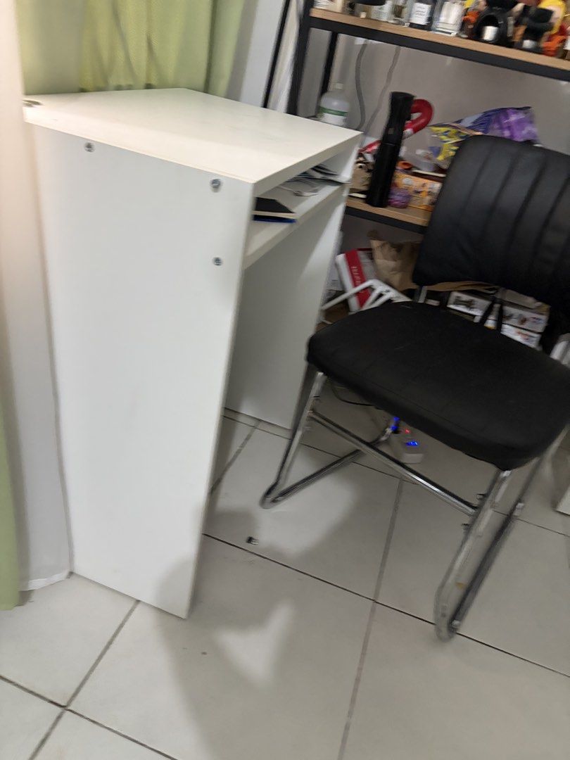 Decluttering: IKEA Study Table (IKEA TORALD DESK) (Category: Tables & Sets) located in Manila. Submitted by herreramar34596 (Listing ID 1470006323, Image 3). Description: - Color & Material: Sturdy white wooden construction - Design: Compact size with straight legs and an open middle shelf for papers and small items - Condition: Minor wear and marks on the surface from regular use; visible screw heads on the side panel Dimensions: 65 x 40 cm (25 