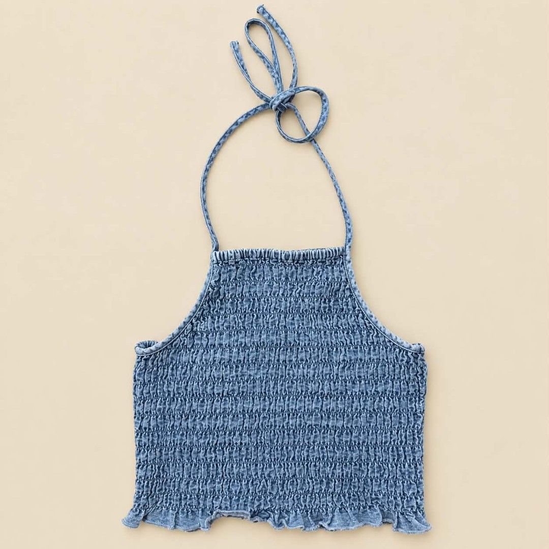 Denim Halter Smocked Crop Top (Category: Sleeveless) located in Manila. Submitted by joshbelgic17602 (Listing ID 1469970884, Image 1). Description: - Denim wash halter top with full body smocking - Secure tie-around neck closure - Fitted silhouette with a playful ruffled hemline - Super stretchy and comfortable snug fit - Versatile piece, great to pair with high-waisted jeans or skirts.