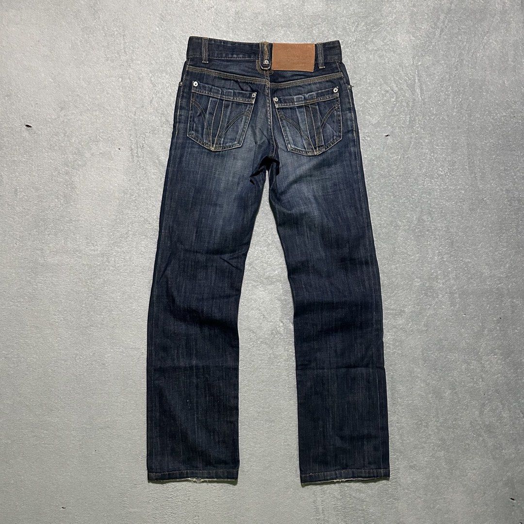 D&G Magic Denim Jeans Size 28 (Category: Jeans) located in Bayombong. Submitted by rochelle_archive_garments (Listing ID 1470040325, Image 2). Description: - Brand/Model: Vintage D&G Magic Denim Jeans - Wash: Dark wash - Size: Tagged Size 28 - Closure: Button fly - Unique Details: Interior waistband printed with global city names, branded leather patch on the back, and distinct stitched detailing on back pockets - Origin: Made in Tunisia - Condit