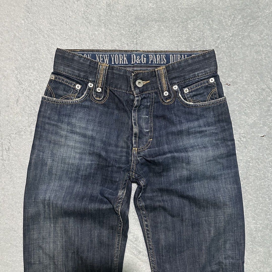 D&G Magic Denim Jeans Size 28 (Category: Jeans) located in Bayombong. Submitted by rochelle_archive_garments (Listing ID 1470040325, Image 3). Description: - Brand/Model: Vintage D&G Magic Denim Jeans - Wash: Dark wash - Size: Tagged Size 28 - Closure: Button fly - Unique Details: Interior waistband printed with global city names, branded leather patch on the back, and distinct stitched detailing on back pockets - Origin: Made in Tunisia - Condit