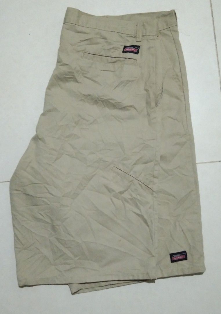 Dickies Khaki Shorts Size 42 (Category: Shorts) located in Manila. Submitted by aj.bermundo (Listing ID 1470021417, Image 1). Description: - Brand: Genuine Dickies - Size: 42 - Color: Classic Khaki - Material: 65% polyester, 35% cotton blend for durability and comfort - Details: Button closure with zip fly, belt loops, and rear welt pockets - Branding: Woven logo patch near the hem and back pocket - Origin: Made in Nicaragua - Condition: Excellen