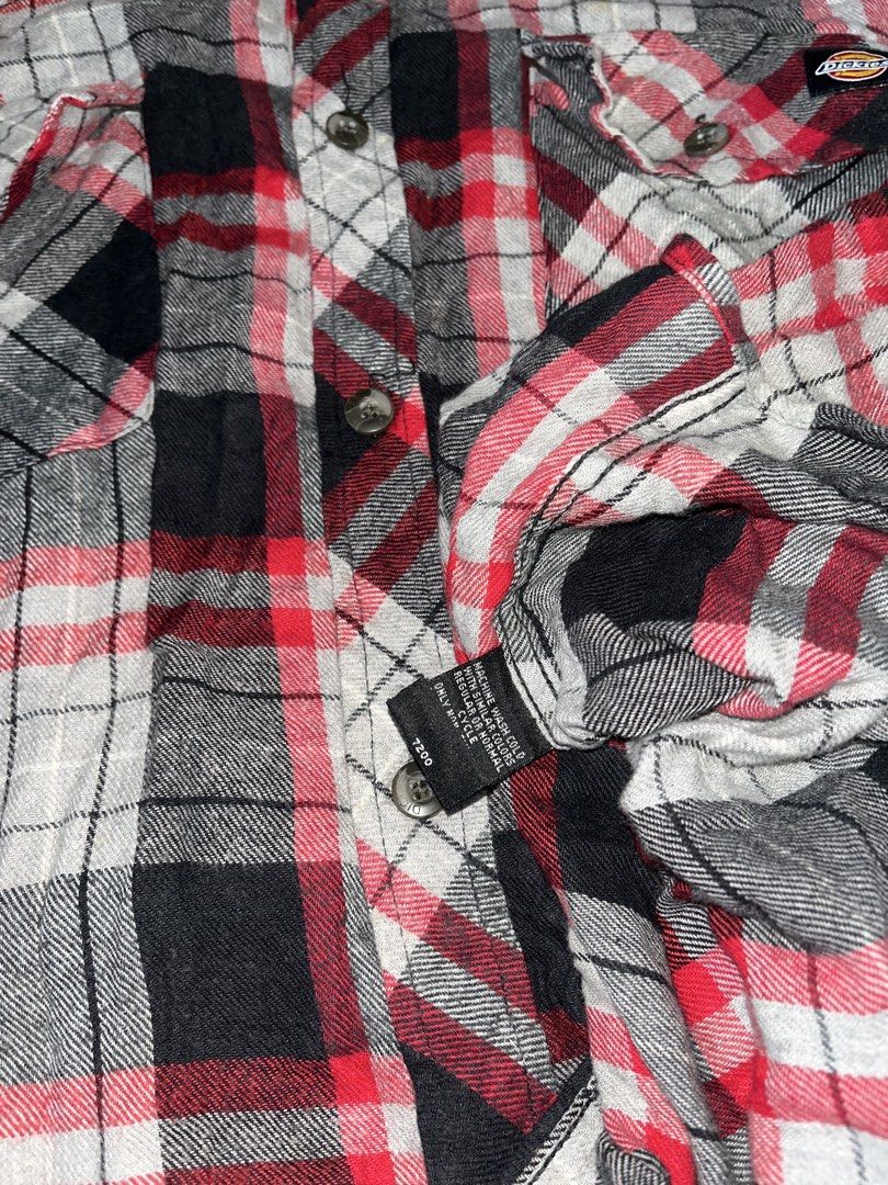 Dickies Red Black Plaid Flannel Shirt (Category: Tshirts & Polo Shirts ) located in Nabua. Submitted by lastthrift2.0 (Listing ID 1469989286, Image 3). Description: Excellent condition - Style: Classic red, black, and white plaid flannel shirt - Size: XL - Material: 100% soft cotton - Features: Dual chest pockets with button closures, button-up front, and button cuffs - Condition: Great for layering in cooler weather.