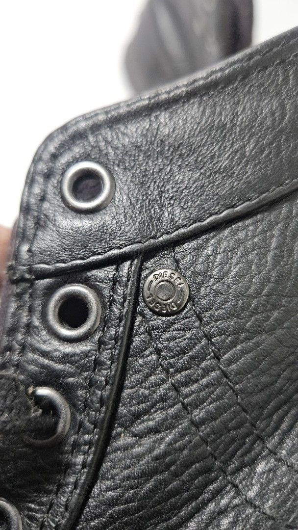 Diesel Black Leather High Top Sneakers (Category: Casual Shoes) located in Alfonso. Submitted by jbcamet (Listing ID 1470018625, Image 3). Description: - Brand: Diesel - Style: High-top sneakers - Material: Premium black leather - Details: Miniature denim side pocket with Diesel Industry branding - Features: Classic rubber toe cap, lace-up closure, and solid black soles - Insoles: Branded with the iconic 'Only The Brave' Mohawk graphic - Conditio