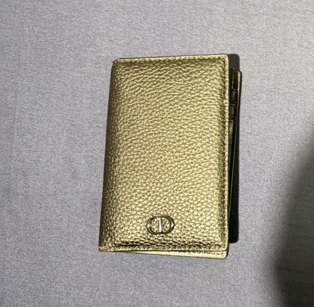Dior Card Holder Wallet (Category: Luxury Bags & Wallets) located in Manila. Submitted by urban.refinds (Listing ID 1470007942, Image 3). Description: - Brand: Dior - Material: Textured gold-tone leather - Design: Compact fold-over with multiple interior card slots - Branding: Metal CD initials on front flap and stamped logo inside - Inclusions: Original dust bag and presentation box included - Condition: Excellent / pristine - GWP - Bought onlin