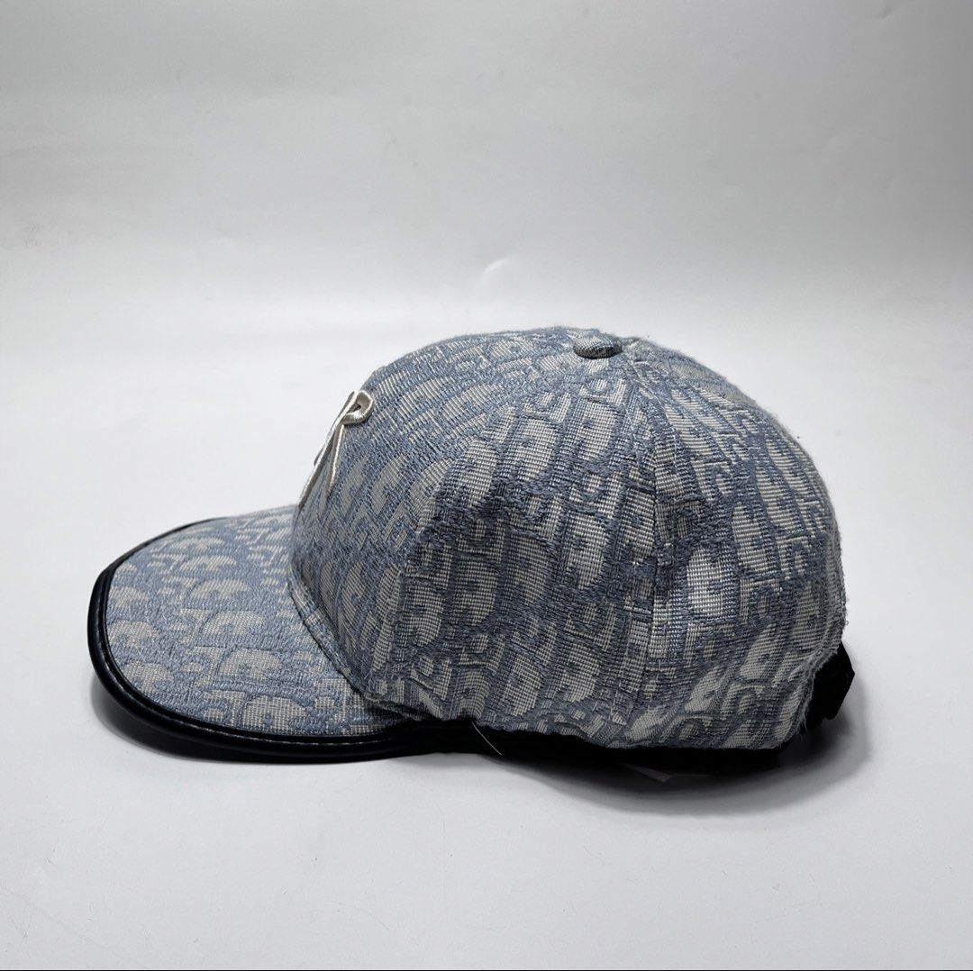 Dior Oblique Blue Monogram Baseball Cap (Category: Caps & Hats) located in Iloilo. Submitted by fromthebins.ilo2 (Listing ID 1470106399, Image 3). Description: - Dior Oblique monogram jacquard baseball cap in blue and grey - White embroidered Dior signature logo on the front - Premium black leather-trimmed curved brim - Adjustable back strap with branded metallic hardware - Grey interior lining with original care tag attached - Condition: Excelle