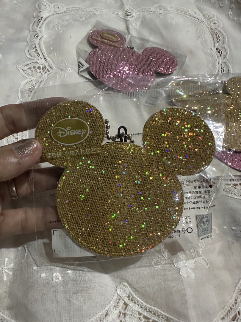 Disney Mickey Moouse-shaped sequin charm pouch with a ball chain. (Category: Charms) located in Davao. Submitted by favoritepreloved (Listing ID 1470058778, Image 3). Description: The back features a Velcro closure, allowing you to store small items inside. 💜 Please note in advance that the item may be slightly folded for shipping. 💜 Colors available: Pink and gold 💜 Back Color: Brown 💜 Design: Mickey Mouse shape, Disney 💜 Material: Fabric, 