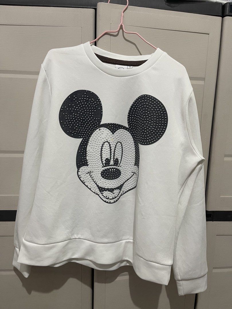 Disney Mickey Mouse White Studded Sweatshirt (Category: Shirts) located in Quezon City. Submitted by zntinycloset (Listing ID 1469981016, Image 3). Description: - Authentic Disney white sweatshirt - Features a large Mickey Mouse graphic made of stylish studs - Size 16 tag at the collar - Long sleeves with comfortable ribbed cuffs and hem - Classic round neckline - Casual and cozy style, ideal for everyday wear.