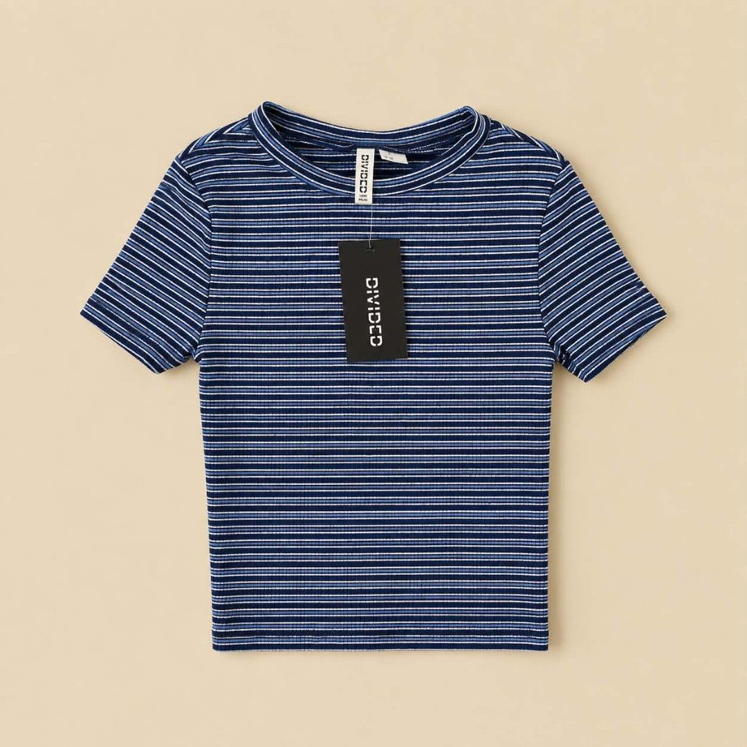 Divided H&M Blue Striped Ribbed Crop Top (Category: Shirts) located in Manila. Submitted by joshbelgic17602 (Listing ID 1469971020, Image 1). Description: - Brand: Divided (paper tag still attached) - Design: Blue and white horizontal stripes - Material: Soft and stretchy ribbed fabric - Fit: Crop top with short sleeves and crew neckline - Condition: Brand new with tags.