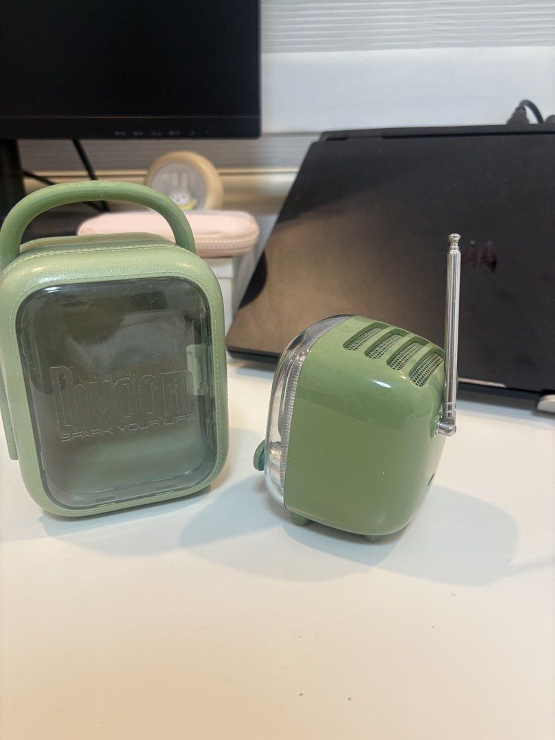 Divoom Tivoo 2 Pixel Art Speaker with Case (Category: Soundbars, Speakers & Amplifiers) located in Noveleta. Submitted by lalastore29 (Listing ID 1470040150, Image 3). Description: Divoom Tivoo 2 pixel art bluetooth speaker in green. Retro TV shape, transparent body, and retractable antenna on top. Comes with matching hard carrying case carrying the Divoom logo. Digital display on the front shows time and animations. Control knobs and buttons at 