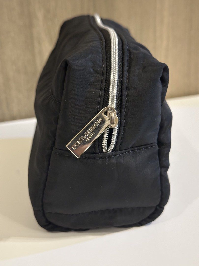 Dolce & Gabbana Beauty Black Makeup Pouch (Category: Purses & Pouches) located in Manila. Submitted by kevintotin49861 (Listing ID 1470090035, Image 2). Description: - Brand: Dolce & Gabbana Beauty - Material: Soft padded nylon in classic black - Hardware: Silver zipper with engraved D&G pull tab - Interior: Clean black fabric with brand tag - Condition: Brand new, never used, properly stored - Perfect compact size for daily makeup essentials in 