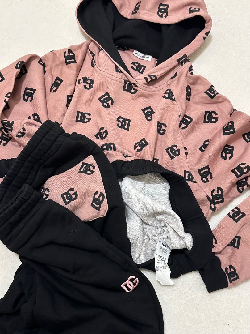 Dolce & Gabbana Pink Black Monogram Tracksuit Set (Category: Luxury Apparel) located in Adams. Submitted by ni-collection26 (Listing ID 1470028408, Image 2). Description: - Brand: Dolce & Gabbana - Set includes: Pink monogram pullover hoodie & matching black joggers - Hoodie details: Black contrasting hood interior and cuffs - Jogger details: Elastic drawstring waistband, cuffed ankles, and single pink monogram back pocket - Material: Ultra-soft 