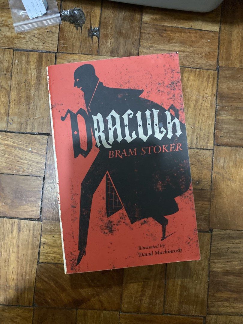 Dracula by Bram Stoker Illustrated Edition (Category: Storybooks) located in Manila. Submitted by solonglondon (Listing ID 1470058958, Image 1). Description: - Title & Author: Dracula by Bram Stoker - Format: Paperback with striking red and black cover art - Features: Illustrated by David Mackintosh - Condition Note: Barcode sticker on the back cover - Genre: Perfect for fans of gothic tales and supernatural fiction.