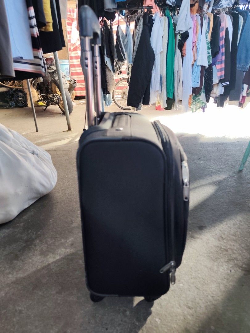 Dunlop Motorsport Black Rolling Suitcase (Category: Luggage) located in Bulacan. Submitted by gelvy1316 (Listing ID 1469947585, Image 3). Description: - Brand: Dunlop Motorsport - Color: Classic black - Ideal for: Short trips and weekend getaways - Mobility: Retractable handle and smooth-rolling wheels - Exterior: Convenient front zipped pocket for quick-access items - Interior: Clean grey branded lining with cross packing straps - Organization: 