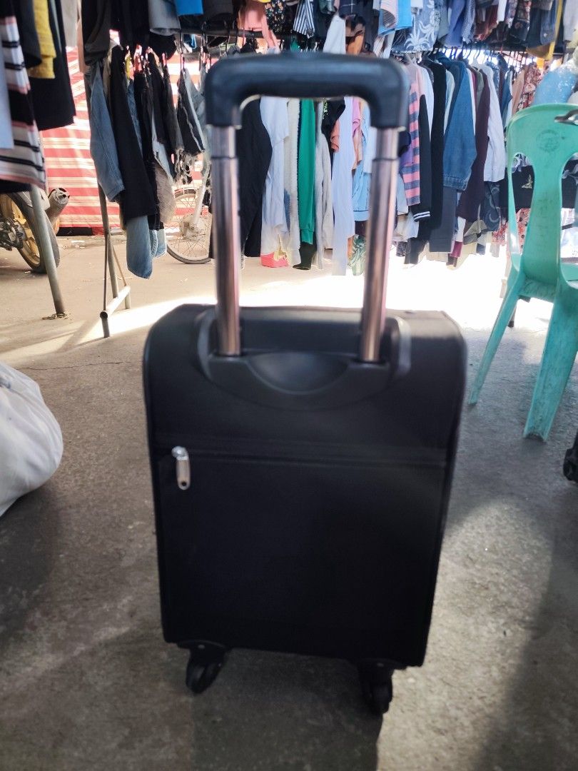 Dunlop Motorsport Black Rolling Suitcase (Category: Luggage) located in Bulacan. Submitted by gelvy1316 (Listing ID 1469947585, Image 1). Description: - Brand: Dunlop Motorsport - Color: Classic black - Ideal for: Short trips and weekend getaways - Mobility: Retractable handle and smooth-rolling wheels - Exterior: Convenient front zipped pocket for quick-access items - Interior: Clean grey branded lining with cross packing straps - Organization: 