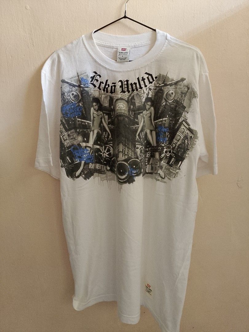 Ecko Unltd Graphic Tee White Size L (Category: Tshirts & Polo Shirts ) located in Caloocan City. Submitted by ricecell (Listing ID 1469980311, Image 1). Description: - Brand: Ecko Unltd - Color: Clean White - Size: L (Tag on collar) - Design: Large gothic-style lettering and cityscape graphic print - Style: Crew neck, short sleeves - Condition: Ready to wear.