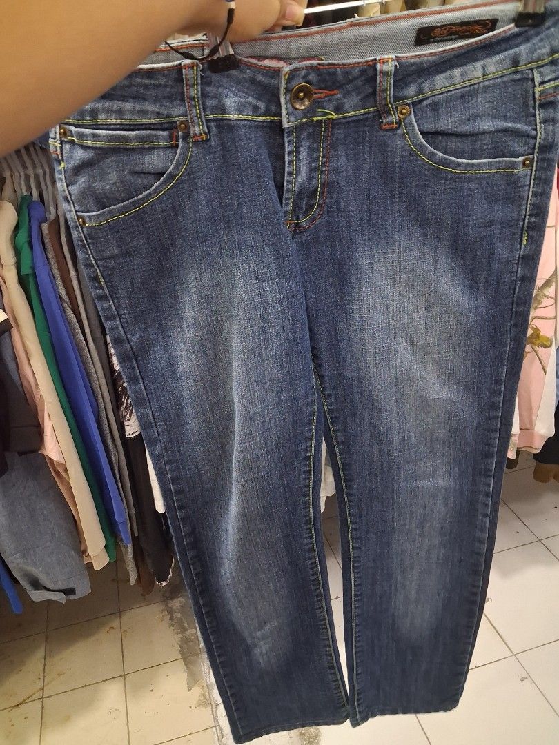 Ed Hardy Skull Denim Jeans y2k (Category: Jeans) located in Manila. Submitted by zafi_ (Listing ID 1470071554, Image 3). Description: - Brand: Ed Hardy - Style: Classic straight leg denim jeans with regular rise - Wash: Classic blue wash - Design: Detailed 'Kills Slowly' skull embroidery on the back pocket - Details: Multi-colored contrast stitching, branded buttons, and interior waistband label - Vibe: Ultimate vintage Y2K streetwear piece - Con
