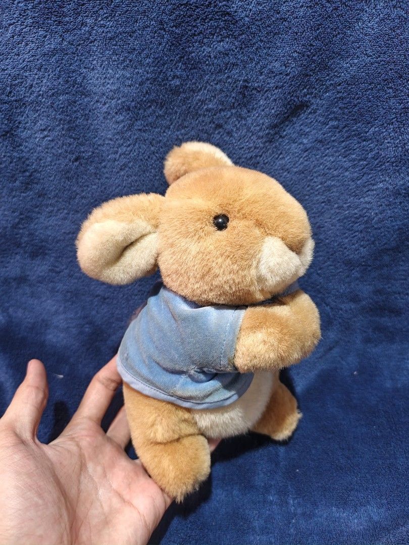 Eden Peter Rabbit Plush Toy with Blue Jacket (Category: Plushies & Soft Toys) located in Manila. Submitted by kirstentoyshub (Listing ID 1470137129, Image 1). Description: - Brand/Character: Eden Peter Rabbit Stuffed Animal - Outfit: Classic blue velour jacket with white belly and tail details - Material: Super soft brown plush fur with classic black button eyes - Condition: Clean, well-maintained, and in great pre-loved condition - Tag: Original