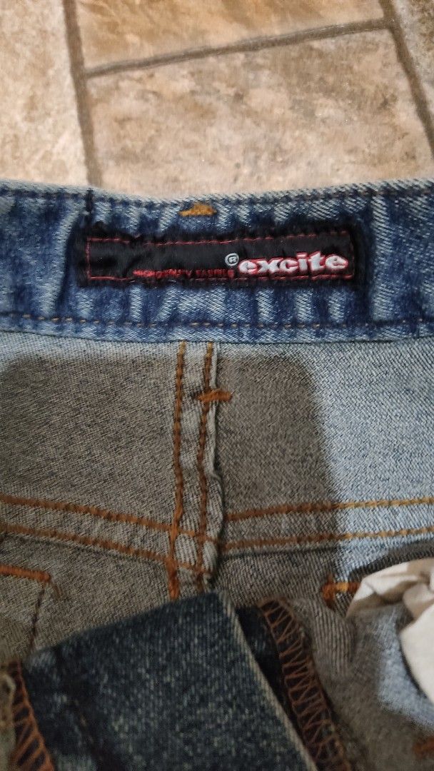 Excite Denim Skirt Medium Wash Front Back Slit (Category: Skirts) located in Mangatarem. Submitted by itsumo_kokoro (Listing ID 1469978925, Image 3). Description: - Brand: Excite - Wash: Medium blue with slight distressing - Style: Classic five-pocket, straight cut, knee-length - Details: Orange contrast stitching, front button and zipper fly, subtle back slit at hem for movement - Material: Sturdy cotton denim - Can fit S-M.