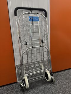 FairPrice red shopping trolley with wheels and extension power strip ...