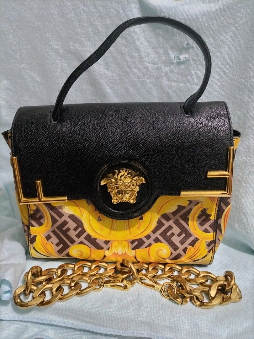 Fendace La Medusa (Category: Shoulder Bags) located in Valenzuela. Submitted by nurzdara28 (Listing ID 1469965486, Image 1). Description: Fendace La Medusa Medium Top Handle Bag. Collaboration: Part of the limited-edition Fendace collection (a collaboration between Versace and Fendi). Design Features: Black grained leather top flap combined with a yellow and brown Baroque/Zucca pattern lower section, accented with the signature gold-tone Versace 
