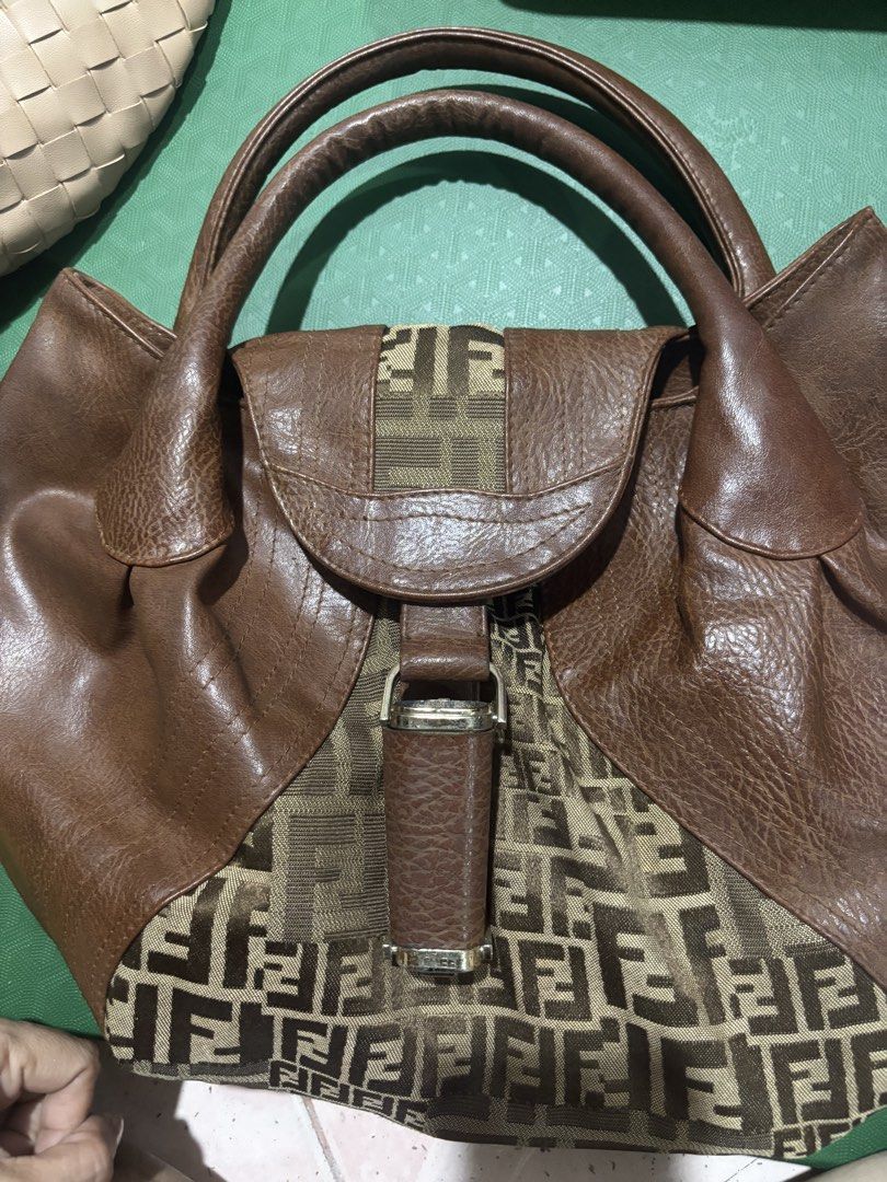 Fendi Zucca Print Brown Leather Handbag (Category: Luxury Bags & Wallets) located in Rizal. Submitted by riri.rarapreloved (Listing ID 1469983462, Image 1). Description: - Brand: Fendi - Material: Brown leather and Zucca monogram fabric - Design: Structured everyday bag with double top handles and flap closure with metallic buckle hardware - Interior: Gold-tone lining with a secure zipper pocket and metal Fendi logo plaque - Condition: Excellent,