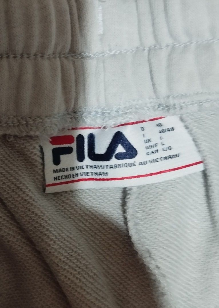 FILA Grey Sweatpants Joggers Size L (Category: Other Bottoms) located in Manila. Submitted by lene48 (Listing ID 1470026898, Image 2). Description: - Brand: Fila - Color: Grey - Size: L - Features: Elastic waistband and cuffed ankles - Detail: Subtle Fila logo on upper leg - Best for: Casual lounging or workouts.