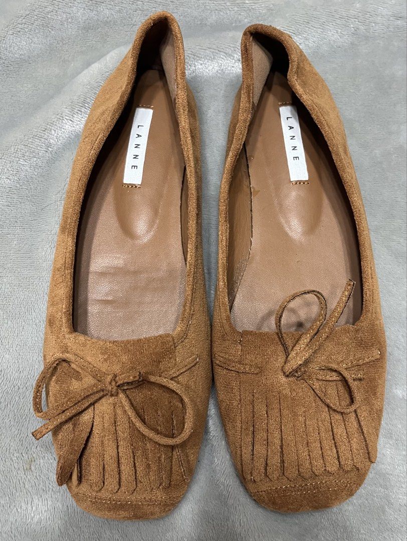 Flat shoes brown (Category: Flats & Sandals) located in Bacoor. Submitted by ayit. (Listing ID 1470042359, Image 1). Description: - Brand: Lanne Once used orig japan gling 10inches /25 cm - Color: Brown - Size: EU 38 / US 7 / UK 5 - Material: Suede-like finish with comfortable inner lining - Design: Elegant square toe with front fringe and bow detailing - Condition: Excellent pre-loved condition with protective tape on soles - Style: Versatile da