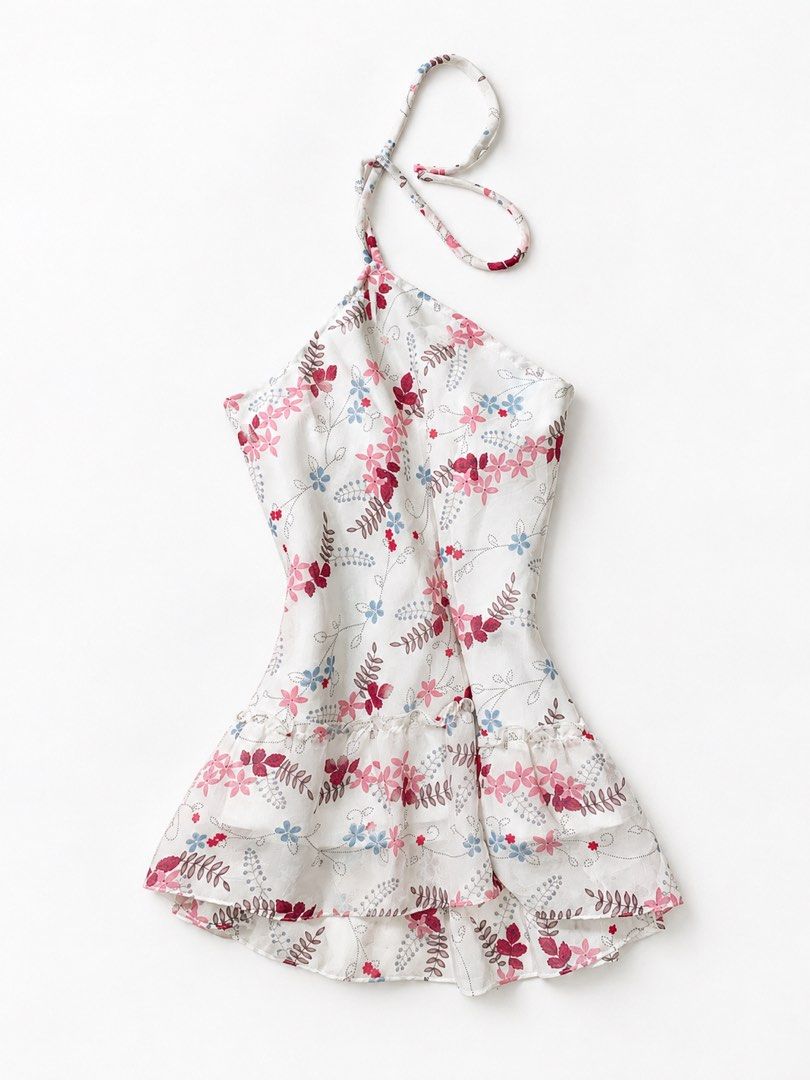 Floral Halter Top with Ruffled Hem (Category: Sleeveless) located in Sarangani. Submitted by solune_clo (Listing ID 1470081762, Image 1). Description: - Design: White halter top with a colorful pink, red, and blue floral and leaf print - Details: Features an adjustable tie neck strap and a cute layered ruffled hem - Comfort: Fully lined with a soft white inner layer for extra comfort - Fabric: Lightweight and breezy, ideal for warm weather and tr