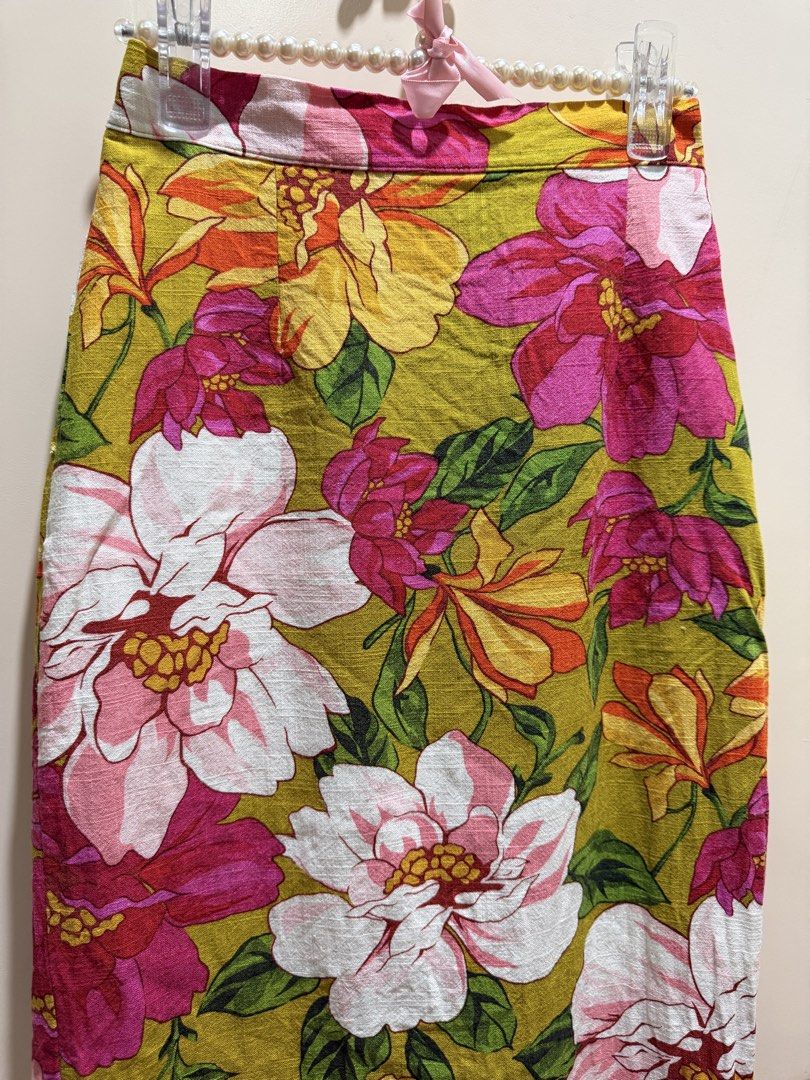 Floral Midi Skirt (Category: Skirts) located in Davao. Submitted by 2ndbase.dvo.ii (Listing ID 1470129210, Image 3). Description: - Style: Straight-cut midi skirt hitting below the calves - Design: Vibrant botanical floral pattern in pink, white, and yellow on an olive green base - Details: Structured waistband, clean zip closure, and back slit for comfort and movement - Fabric: Lightweight and breathable, ideal for warm weather - Condition: Bran