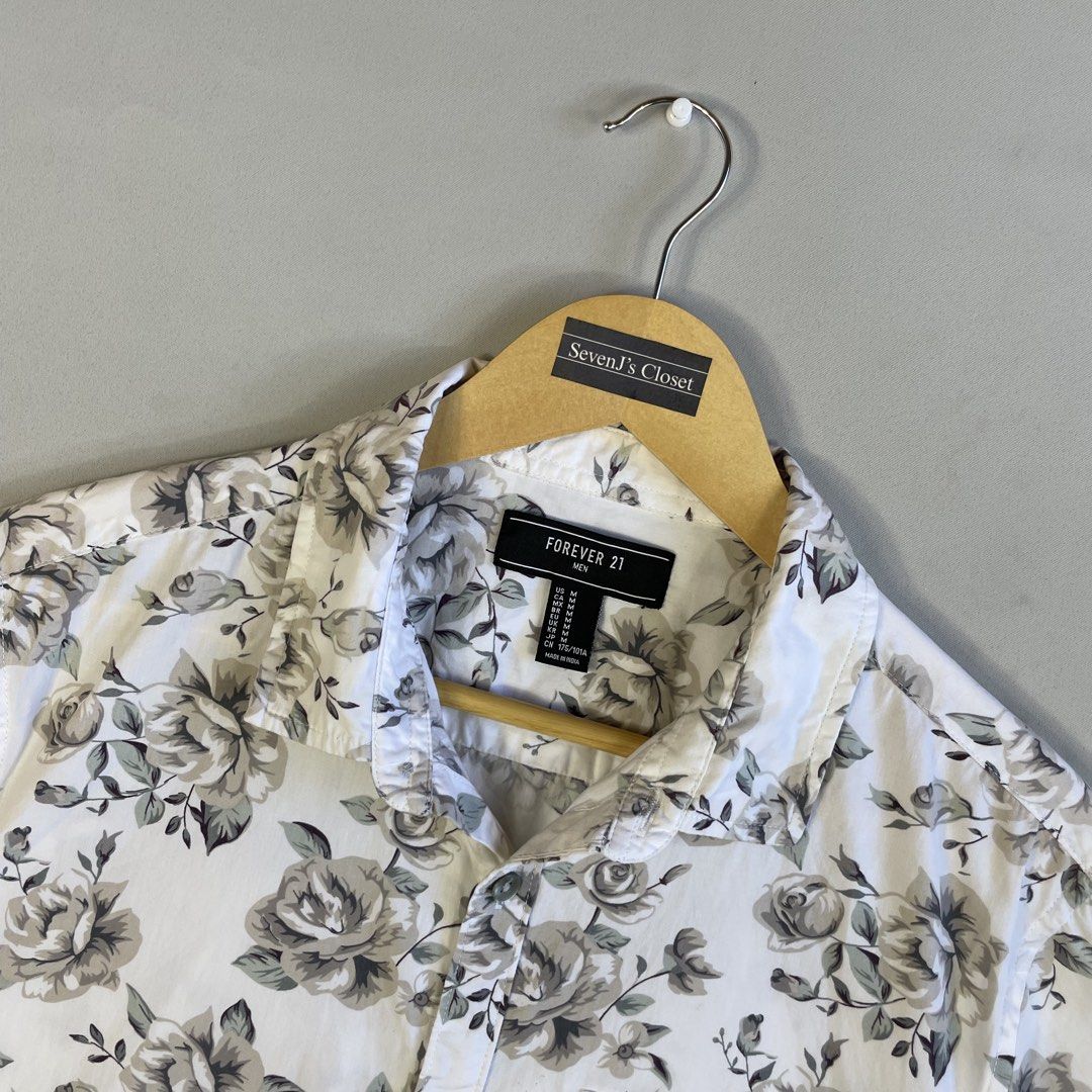 FOREVER 21 | Monochrome Floral Button-Down Shirt (Category: Tshirts & Polo Shirts ) located in Manila. Submitted by sevenjscloset (Listing ID 1469996292, Image 2). Description: - Brand: Forever 21 - Style: Monochrome floral short-sleeve button-down shirt - Size: Medium (Length: 27", Width: 20") - Design: White base with an all-over grey and black rose pattern, single chest pocket, front button closure - Model reference: 5'10" and 70kg for fit.