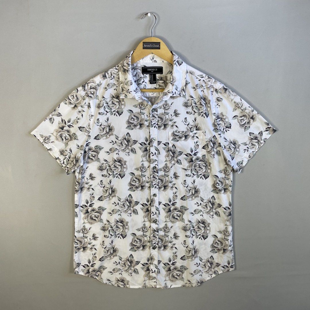 FOREVER 21 | Monochrome Floral Button-Down Shirt (Category: Tshirts & Polo Shirts ) located in Manila. Submitted by sevenjscloset (Listing ID 1469996292, Image 1). Description: - Brand: Forever 21 - Style: Monochrome floral short-sleeve button-down shirt - Size: Medium (Length: 27", Width: 20") - Design: White base with an all-over grey and black rose pattern, single chest pocket, front button closure - Model reference: 5'10" and 70kg for fit.