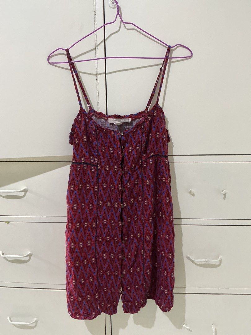 Forever 21 Aztec Print Button Front Camisole Dress (Category: Dresses) located in Rizal. Submitted by kyliemaine (Listing ID 1470032397, Image 1). Description: - Brand: Forever 21 - Size: S - Design: Vibrant red and blue Aztec pattern with lace-trim paneling - Features: Adjustable spaghetti straps, button-down front with metal buttons, and gathered neckline - Material: Lightweight fabric - Style: Casual summer piece, easy to pair with sandals or 