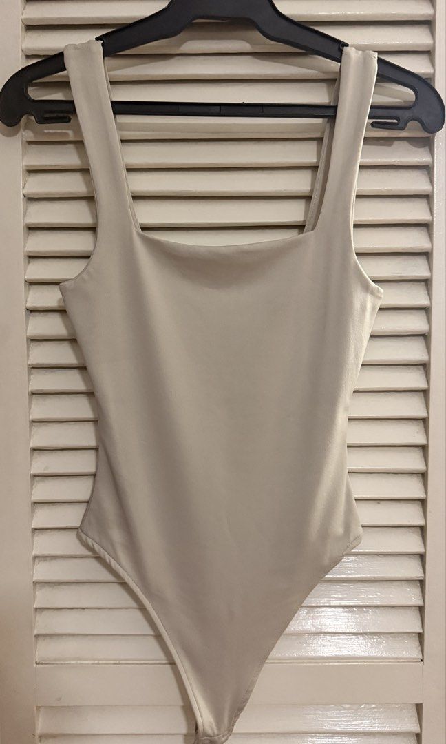 Forever 21 Beige Square Neck Bodysuit (Category: Sleeveless) located in Quezon City. Submitted by oliviablanche (Listing ID 1470085540, Image 1). Description: - Brand: Forever 21 - Size: XS - Color: Light Beige / Nude - Neckline: Square neckline with wide tank straps and square back cut - Details: Smooth, stretch fabric with a fitted silhouette and snap-button closure at the bottom - Styling: Minimalist wardrobe staple, perfect for pairing with h
