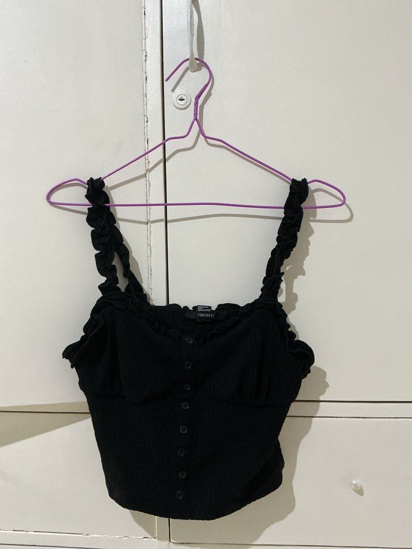 Forever 21 Black Ribbed Ruffle Crop Top (Category: Sleeveless) located in Rizal. Submitted by kyliemaine (Listing ID 1470034684, Image 1). Description: - Brand: Forever 21 - Size: Small - Color: Black - Style: Cropped, fitted ribbed top - Details: Square neckline, ruffled straps, and center front button closure - Perfect for pairing with high-waisted jeans, shorts, or skirts.