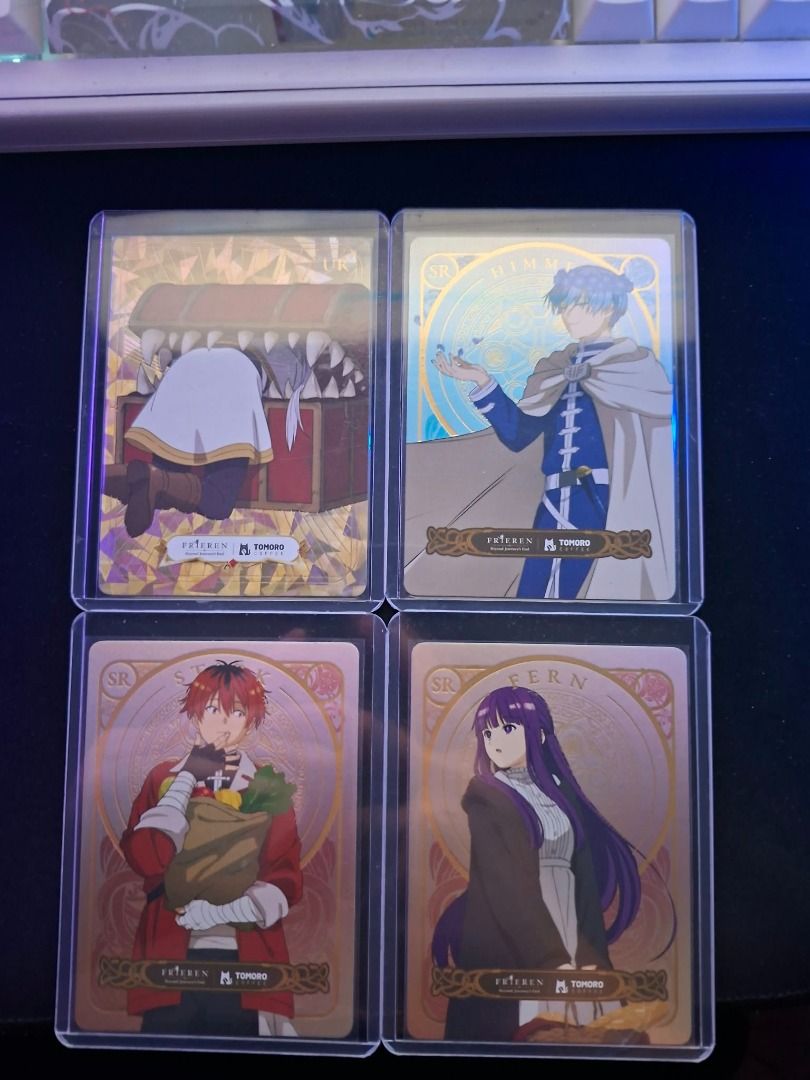 Frieren x Tomoro (Category: Designer & Blind Box Toys) located in Quezon City. Submitted by jordump (Listing ID 1470131443, Image 1). Description: Frieren x Tomoro cards w/ free sleeve and top loader 1 Ultra rare (UR) - Mimic Frieren 3 Super rare (SR) - Fern/Himmel/Stark Very good condition.