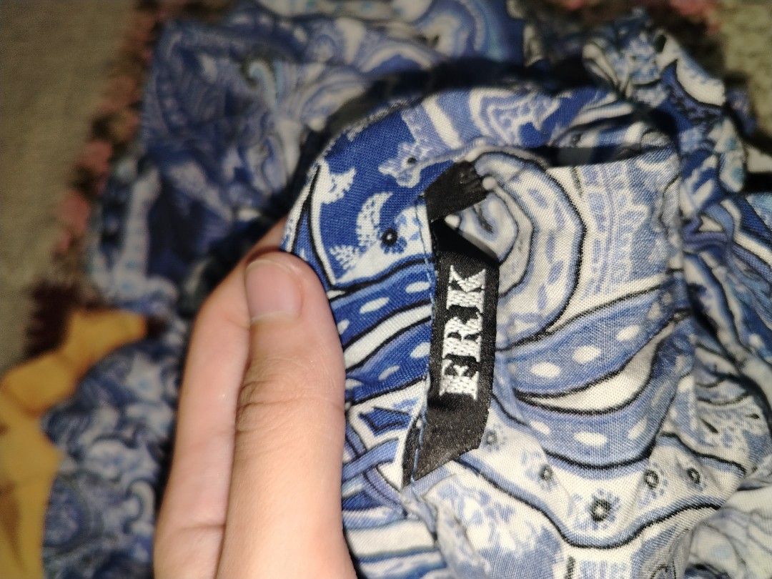 FRK Blue Paisley Halter Neck Top (Category: Sleeveless) located in Batangas. Submitted by themostbyz (Listing ID 1470087765, Image 2). Description: - Brand: FRK - S-M - Design: Blue and white paisley print - Fit: Fitted body with a stylish flared hem - Details: Secure tie-neck with matching straps - Material: Lightweight and breathable fabric - Condition: Excellent, clean with no flaws.