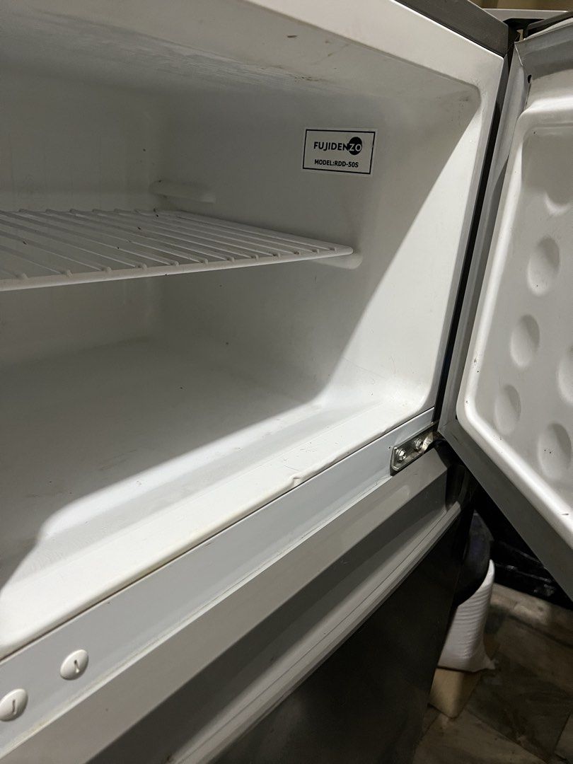 Fujidenzo RDD-50S Two Door Refrigerator (Category: Refrigerators and Freezers) located in Quezon City. Submitted by swiftiesince08 (Listing ID 1470010249, Image 2). Description: - Brand/Model: Fujidenzo RDD-50S Two-Door Mini Refrigerator - Color: Sleek Dark Grey exterior with white interior - Storage: Wire shelves, bottom crisper drawer, freezer shelf, and convenient door bins on both doors - Performance: Energy efficient and heavy-duty build - C