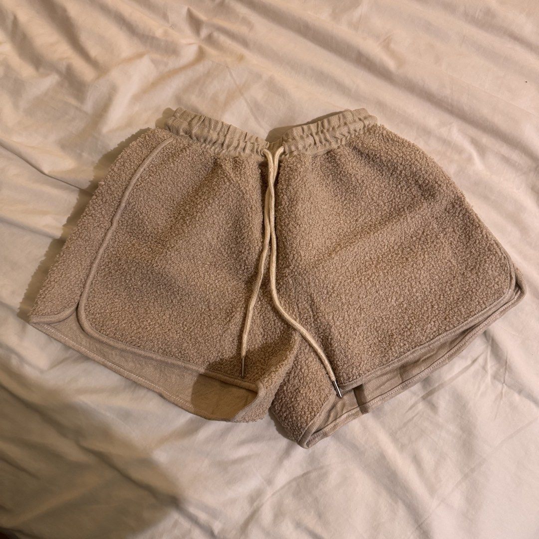 Fuzzy beige sherpa lounge shorts with drawstring (Category: Shorts) located in Quezon City. Submitted by ianne.declutter (Listing ID 1470086230, Image 1). Description: worn once to fit fits up to size 24-26 only anything beyond that wont fit na - Color: Beige - Material: Super soft sherpa fleece - Waistband: Elastic with adjustable drawstring and metal aglets - Fit: Relaxed fit with flattering curved hems - Use: Perfect for relaxing at home or sl