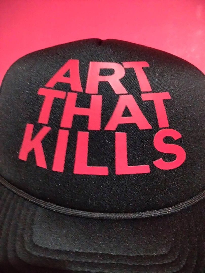 Gallery Dept. Art That Kills Trucker Hat (Category: Caps & Hats) located in Mangaldan. Submitted by niftythrifty69 (Listing ID 1470051735, Image 2). Description: - Brand: Gallery Dept. - Style: Black trucker hat with curved brim - Design: Bold red "ART THAT KILLS" front foam panel print - Fit: Adjustable snapback closure - Comfort: Breathable mesh back - Authenticity: Includes interior Gallery Dept. branding tag - Condition: Clean shape, classic 