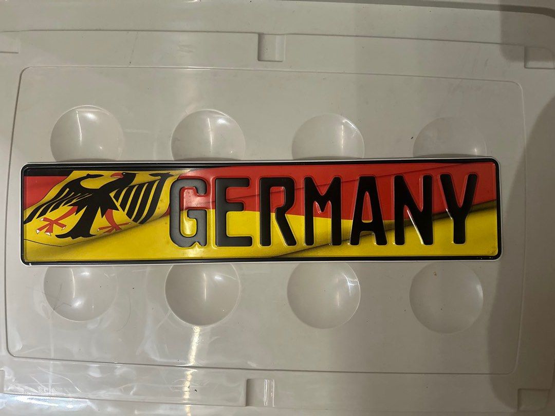 Germany Novelty Decorative Plate (Category: Vintage Collectibles) located in Quezon City. Submitted by bqchane (Listing ID 1470056080, Image 1). Description: - Material: Sturdy aluminum with clean, vibrant yellow, red, and black print - Design: Embossed 'Germany' lettering featuring the national eagle crest and German flag background - Dimensions: Standard rectangular shape with pre-punched mounting holes for easy hanging - Ideal Use: Perfect wal