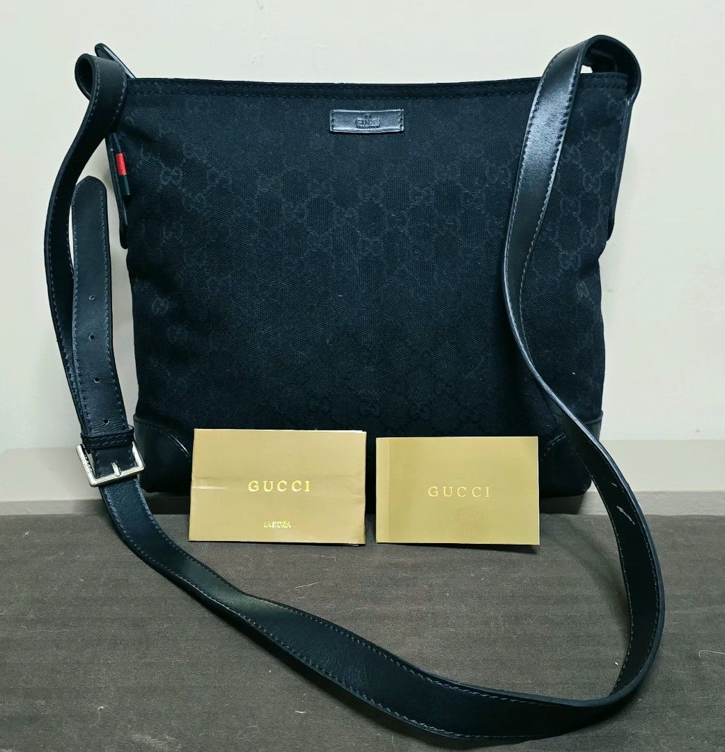 GG Messenger Bag Black Canvas (Category: Cross-body Bags) located in Manila. Submitted by ubasirene (Listing ID 1470080460, Image 2). Description: - Gucci GG messenger bag in classic black canvas with leather trim - Adjustable leather strap with branded silver-tone hardware - Features iconic red and green web detail on the side - Clean black interior and exterior with a secure top zip closure - Spacious everyday bag that easily fits your daily es