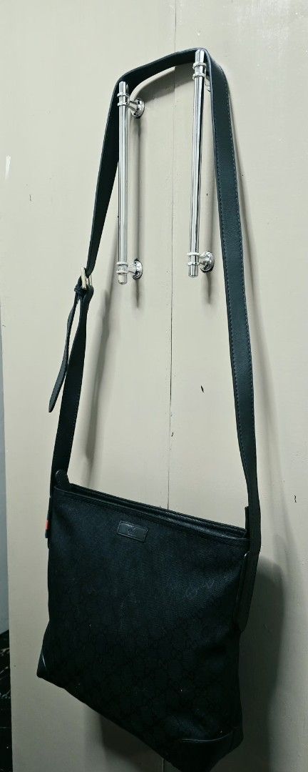 GG Messenger Bag Black Canvas (Category: Cross-body Bags) located in Manila. Submitted by ubasirene (Listing ID 1470080460, Image 3). Description: - Gucci GG messenger bag in classic black canvas with leather trim - Adjustable leather strap with branded silver-tone hardware - Features iconic red and green web detail on the side - Clean black interior and exterior with a secure top zip closure - Spacious everyday bag that easily fits your daily es
